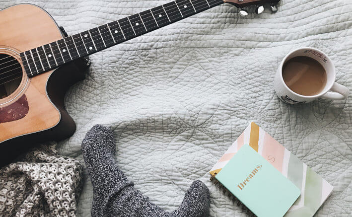 Feet, guitar, notebook and a coffee