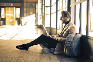 Man learning Spanish online in an Airport